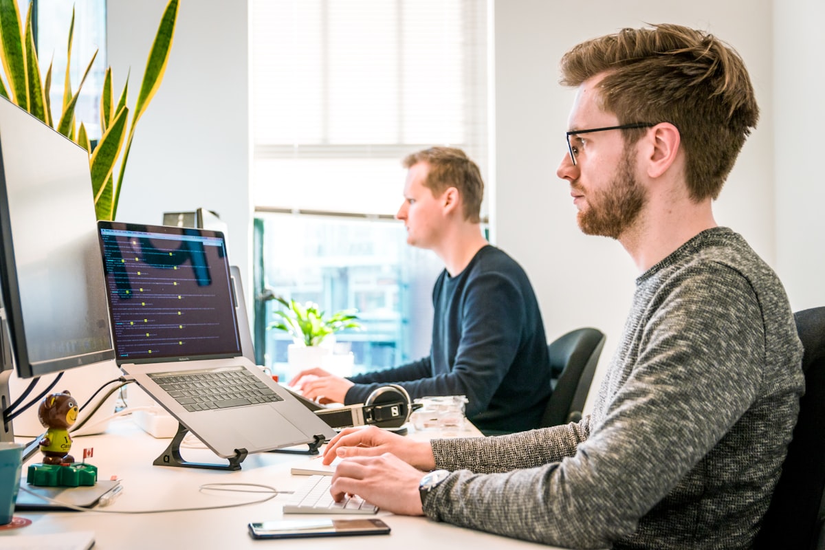 Two business partners shaking hands in a modern office